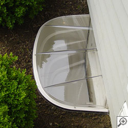 A covered plastic basement window well in Bettendorf.