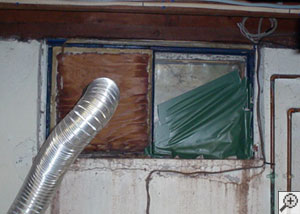 A basement window system that's rotted and  has been damaged over time in East Peoria.