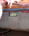 Illinois and Iowa crawl space with vents, showing mold, rot, and fiberglass insulation dripping off the ceiling.