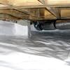 Bare floor joists in a sealed, insulated crawl space in Iowa City.