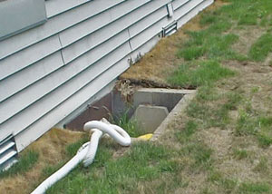The ugly, old concrete window well of a Davenport crawl space