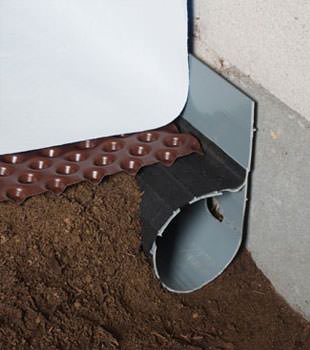 Closeup of a crawl space drainage system installed in Spring Valley