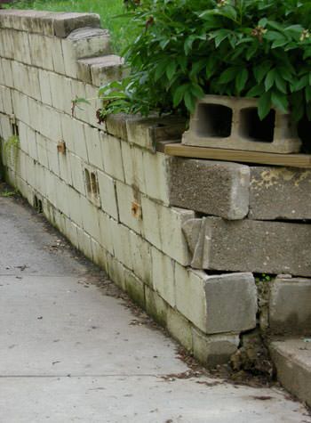collapsing retaining wall with severe damage in Coralville