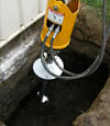 Installing a helical pier during a foundation repair in Bloomington