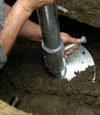 Bloomington helical pier installation nearing completion, with the blade being advanced into the foundation soils.