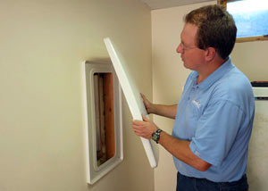 Foundation wall anchor covers installed in a finished basement with a repaired foundation wall in Spring Valley.