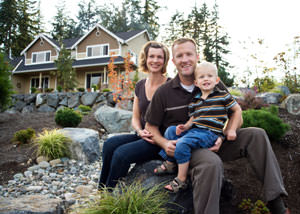 A happy family outside a home with a repaired foundation in La Salle