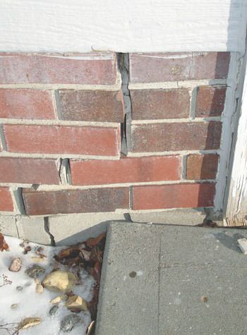 Severe street creep damage to a garage wall outside a Coal Valley home