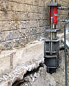 A completed installation of foundation push piers lifting a foundation in Freeport