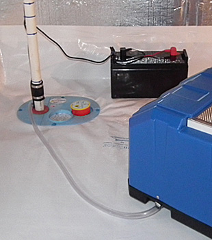 Closeup of a crawl space sump pump installed in Normal