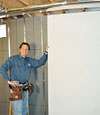 Installing wall panels on top of our basement wall insulation in Dubuque