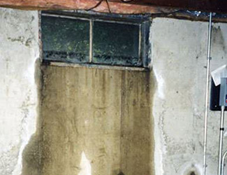 Water pouring out from a basement window in Waterloo