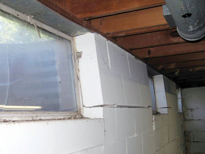 Bowing Foundation Wall Repairs In Peoria Cedar Rapids Davenport A Foundation Showing Severe Inward Buckling Along The Windows In Freeport Home